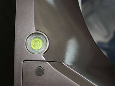 There is a yellow plastic circular level vial with scale on it.